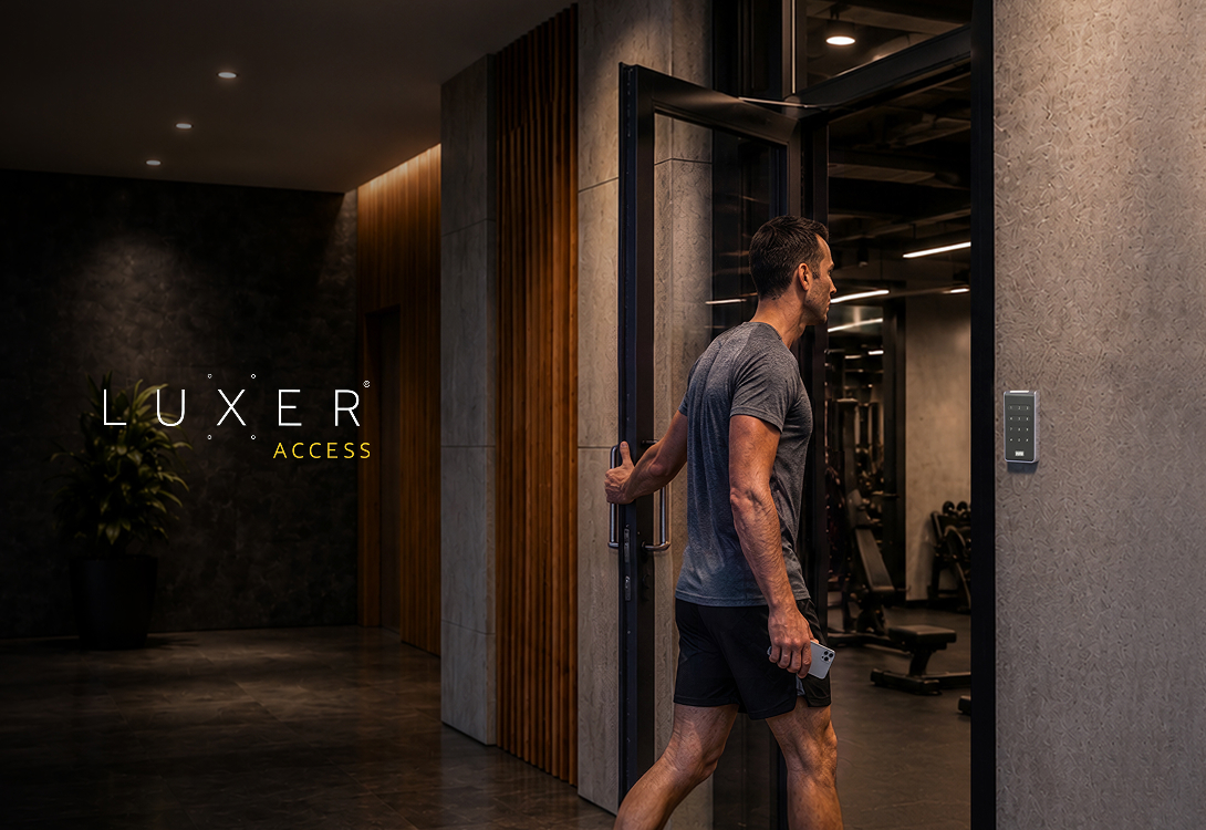 Resident entering an apartment gym using a Luxer Access reader for keyless entry.