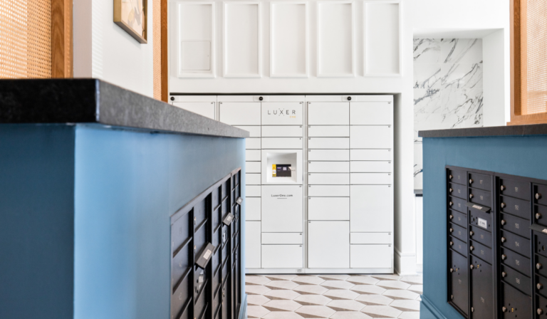 Luxer One white smart package lockers in multifamily apartment building
